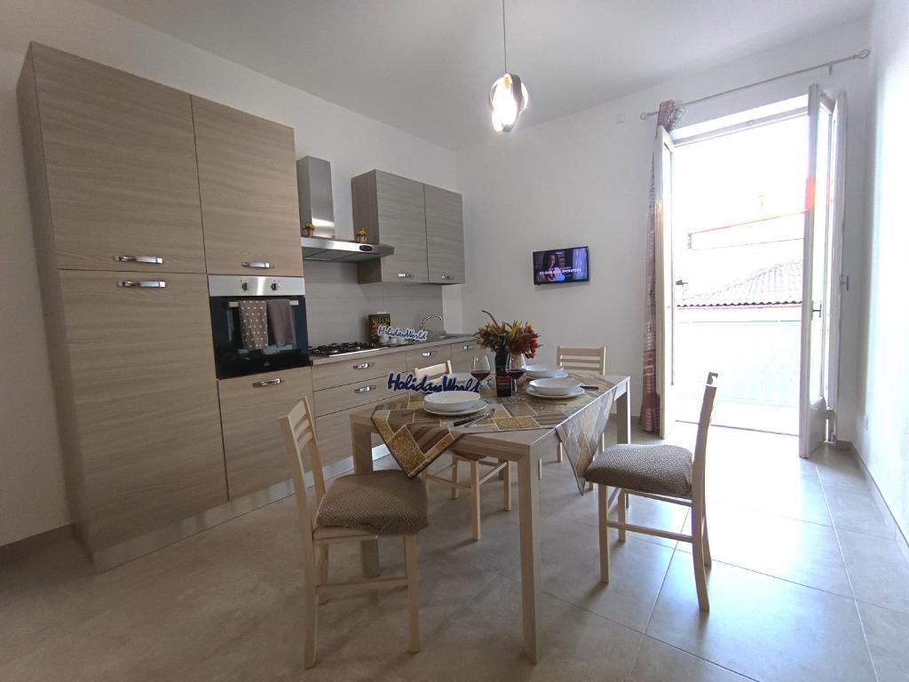 a kitchen with a table and chairs in a room at Da Nonna Melina by Holiday World in Licata