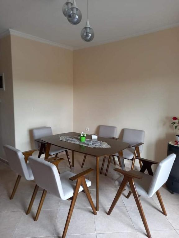 a dining room with a table and chairs at Anzhela apartment in Nea Roda