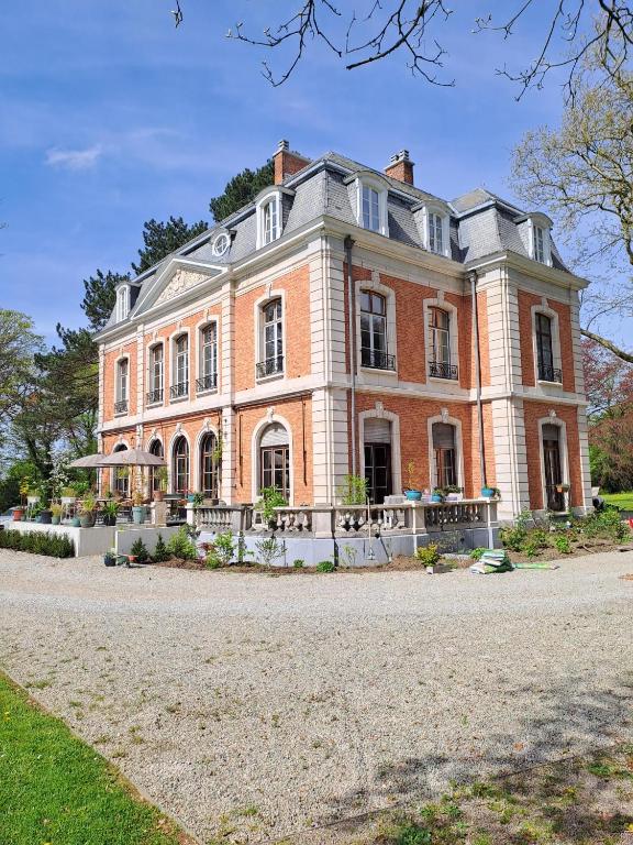 a large brick house on a dirt road at Le Petit Château Peltzer in Verviers