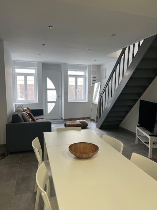 a living room with a table with a bowl on it at La Maison Saint-Adrien in Boulogne-sur-Mer