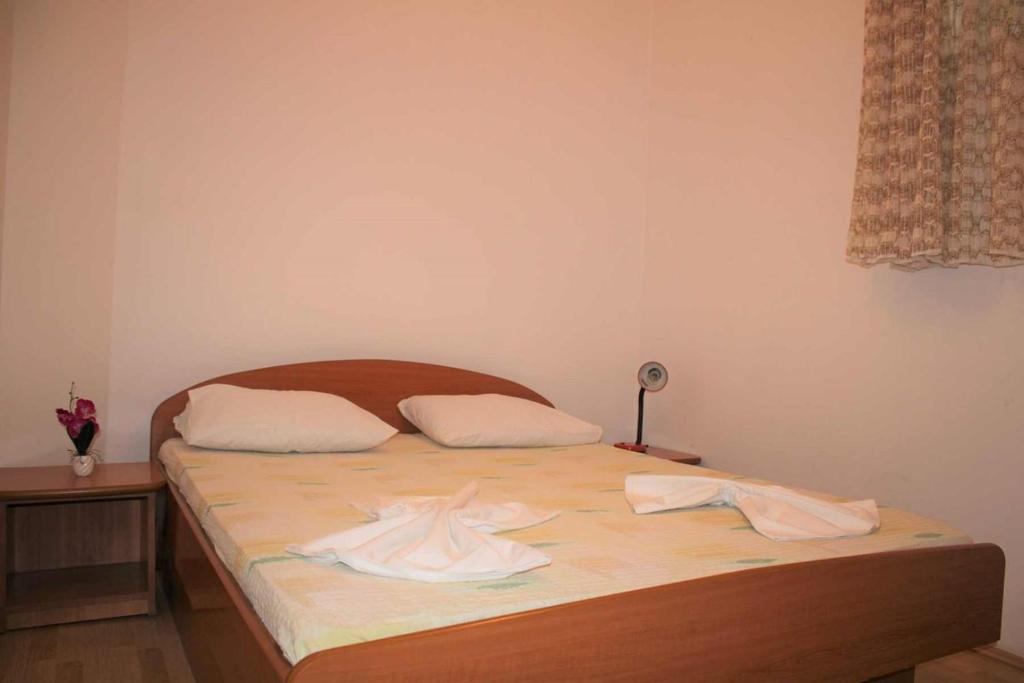 Postel nebo postele na pokoji v ubytování Apartments Pidi