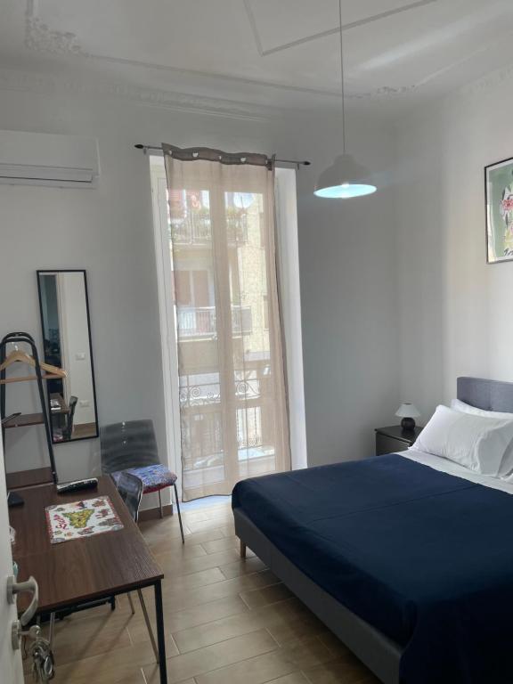 a bedroom with a blue bed and a mirror at Maison L'amuri in Palermo