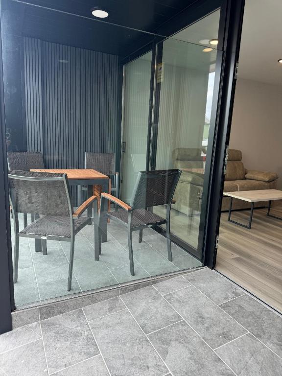 a dining room with a table and chairs and a couch at Apartamentos Turísticos Vidal Costa in Foz