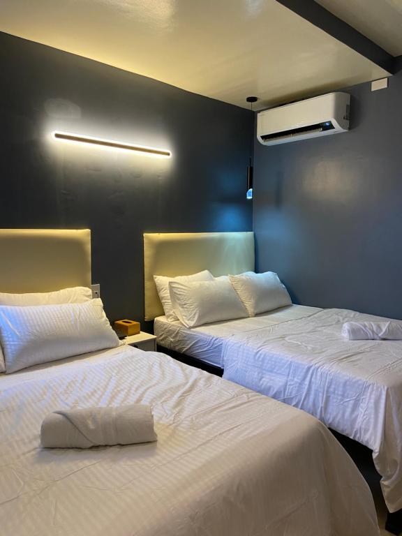 Postel nebo postele na pokoji v ubytování IAO Boutique Hotel