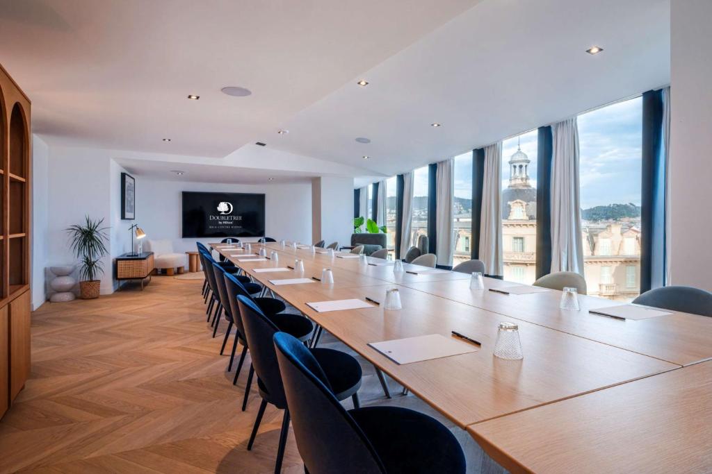 a large conference room with a long table and chairs at Doubletree By Hilton Nice Centre Iconic in Nice