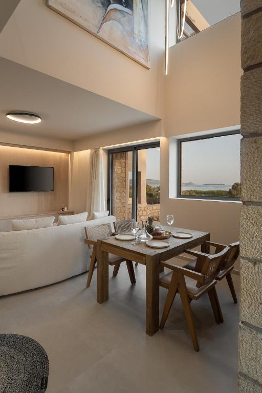a living room with a table and a couch at Piccadill Luxury Villas in Methoni