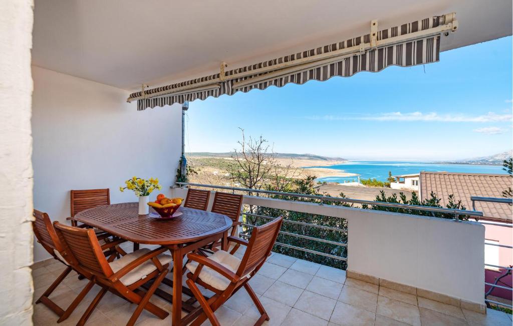 a dining room with a table and chairs on a balcony at Stunning Home In Rovanjska With Wifi in Rovanjska