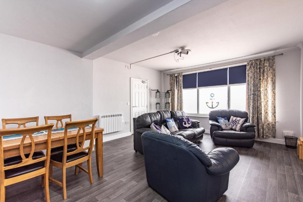 a living room with a table and chairs and a dining room at Maritime House Two - 4BR Sleeps 10 Near City Centre in Hull