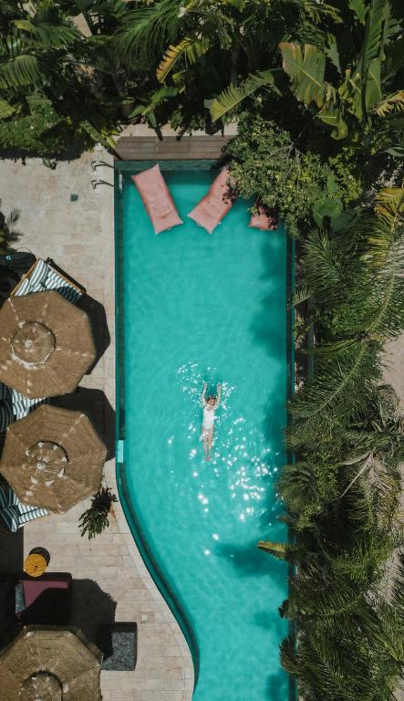 a person is swimming in a swimming pool at Villa Balfour in Eilat