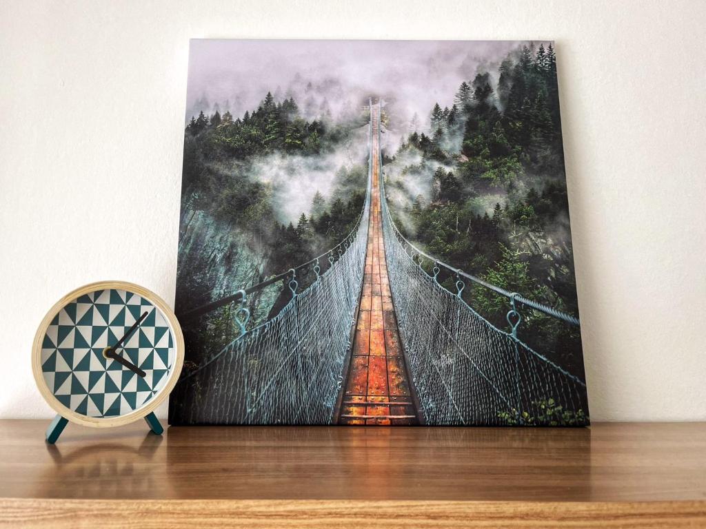 a painting of a suspension bridge in the forest at Penthouse near Red Bull Ring in Knittelfeld