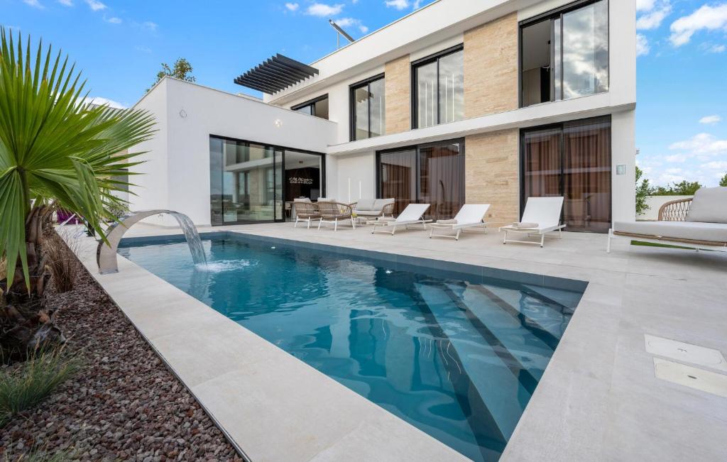 a swimming pool in front of a house at Villa Lux1 Tribunj in Tribunj