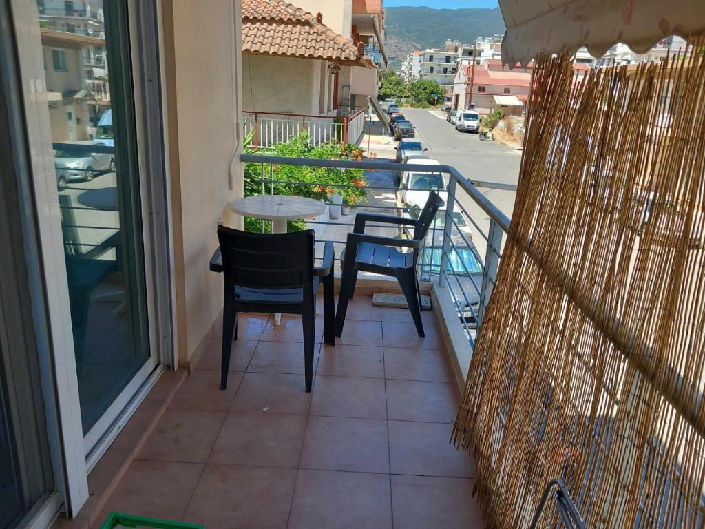 a balcony with a table and chairs on a balcony at Central 26 apartment in Kalamata in Kalamata