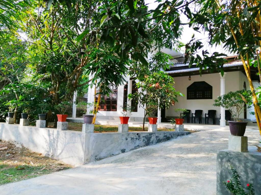 a house with trees in front of it at Green Hill Villa in Unawatuna