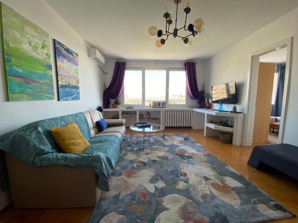 a living room with a couch and a table at The Dome, Sala Palatului, walking distance to the Old town in Bucharest
