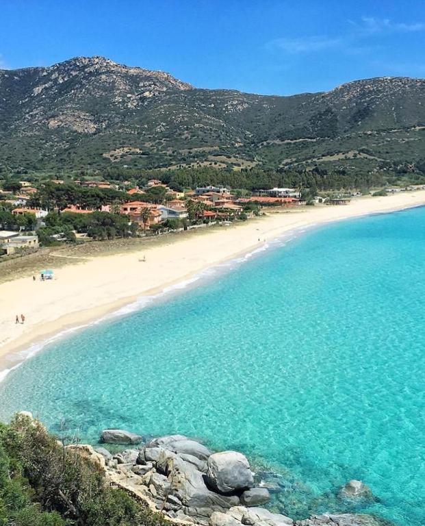 an aerial view of a beach with people in the water at B&B Is Pranus a Mari Casa Privata in Solanas
