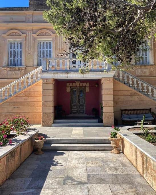 a building with a staircase leading to a door at Villa Iren in Parakopí