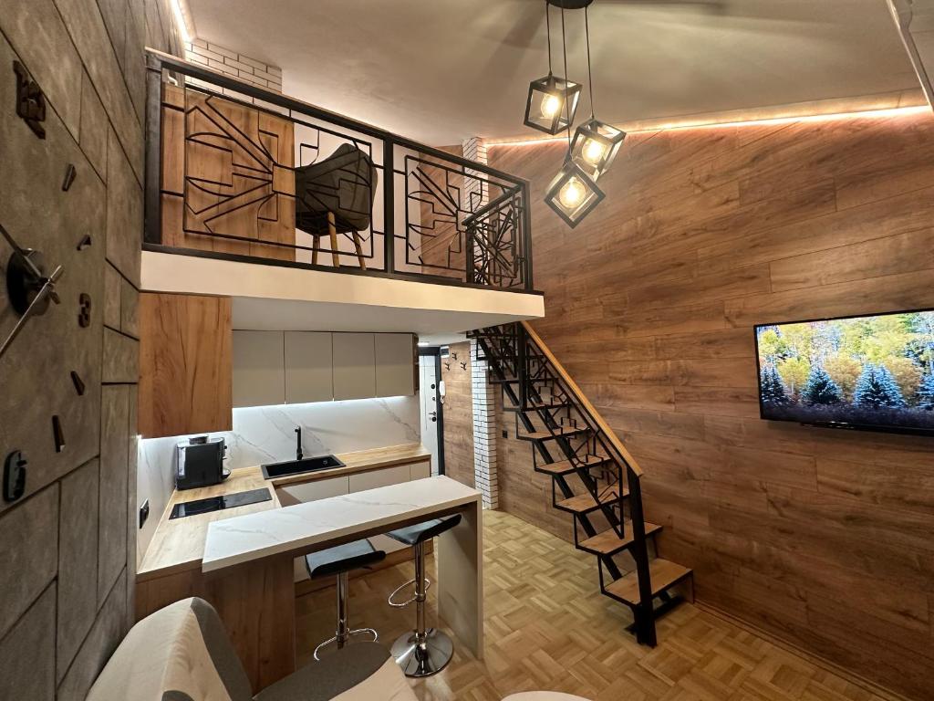a spiral staircase in a room with wooden walls at Studio Lazur in Burgas