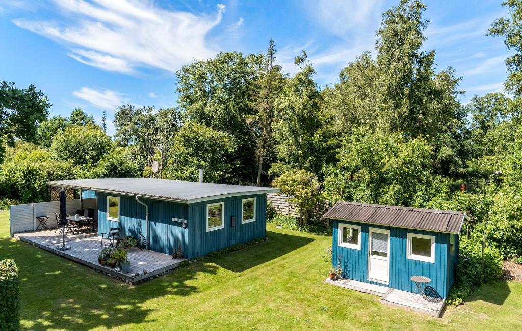 a tiny house in a garden with a patio at 2 Bedroom Nice Home In Samsø in Samsø