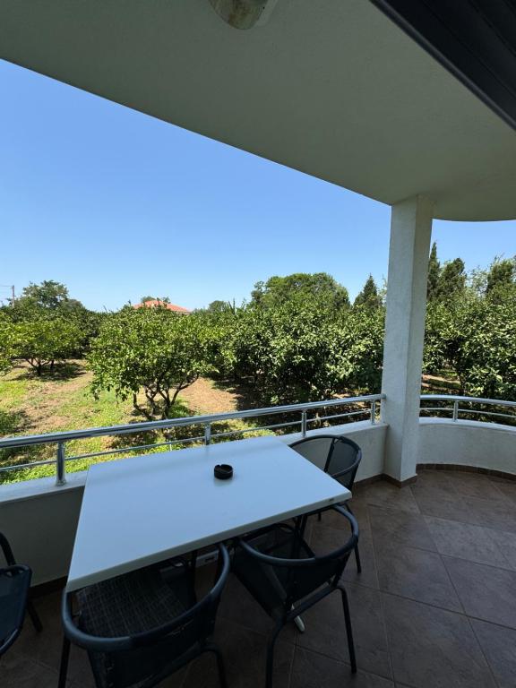 a white table and chairs on a balcony at Sunrise house apartments in Ulcinj