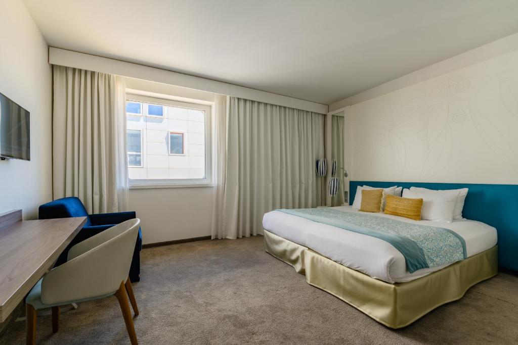 Postel nebo postele na pokoji v ubytování Golden Tulip Marseille Euromed