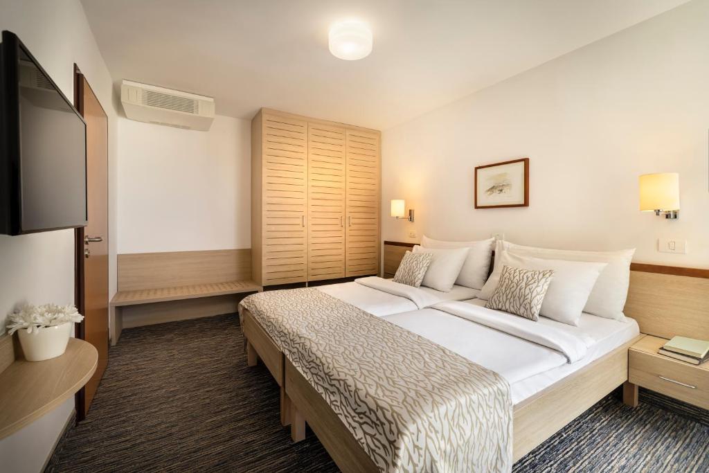 Postel nebo postele na pokoji v ubytování Valamar Sanfior Hotel & Casa