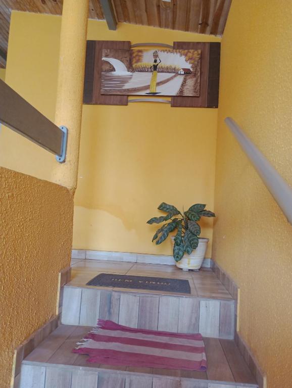a room with a stairs with a painting on the wall at Mariana Chale in São Miguel do Gostoso