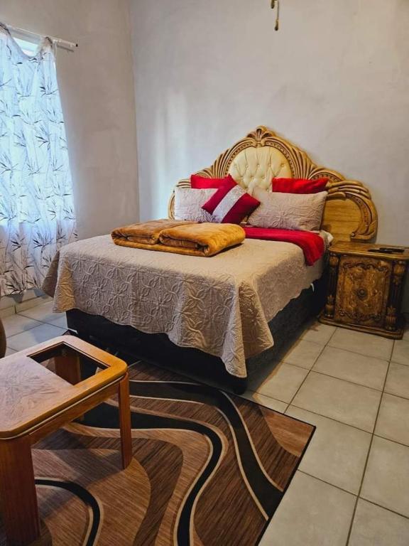 a bedroom with a bed with pillows on it at Goodlife guest house in klerksdorp in Klerksdorp