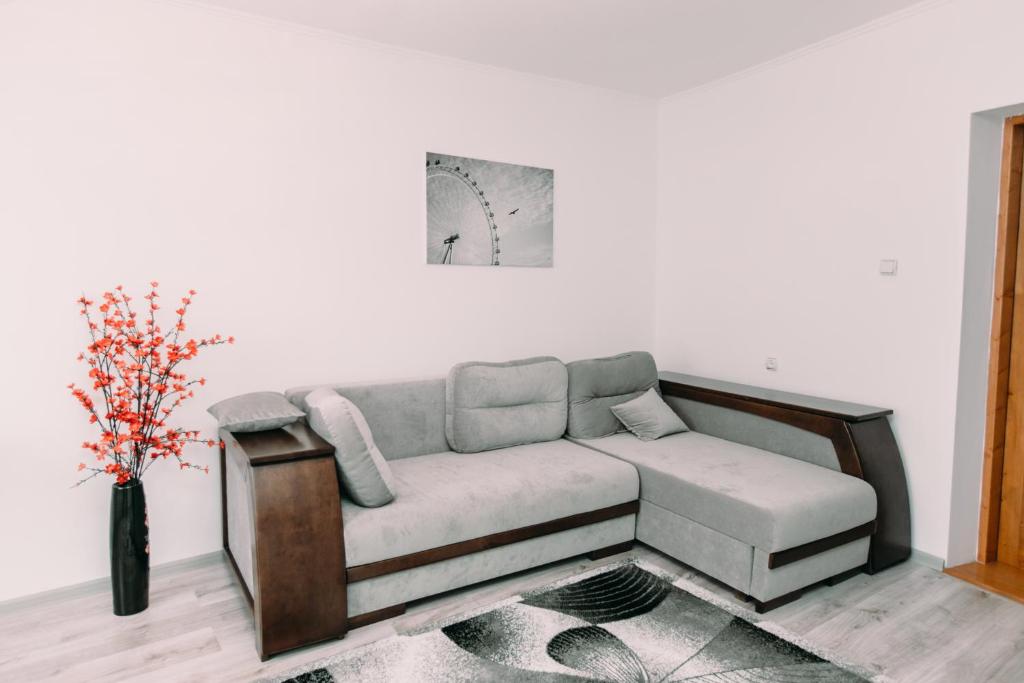 a living room with a couch and a vase of flowers at Apartments in Uzhgorod in Uzhhorod