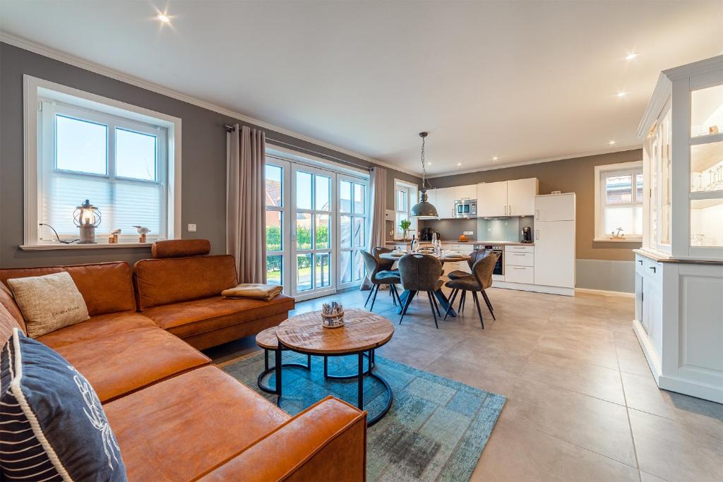 a living room with a couch and a table at Hus in Luv in Greetsiel