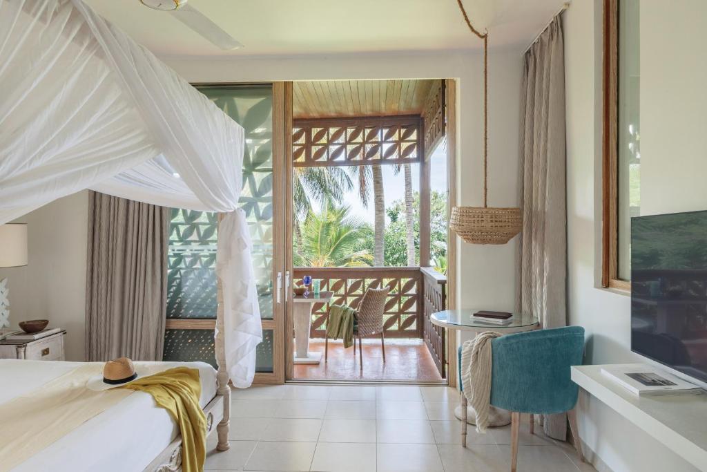 Postel nebo postele na pokoji v ubytování Melia Zanzibar