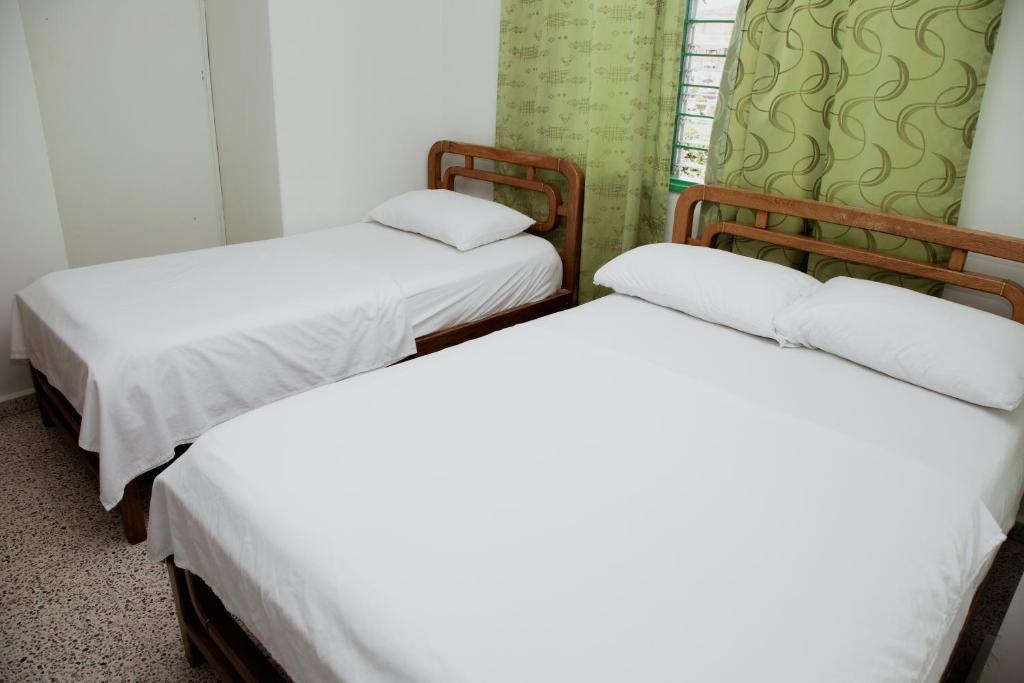 Postel nebo postele na pokoji v ubytování Hotel Casa Verde Guatapé
