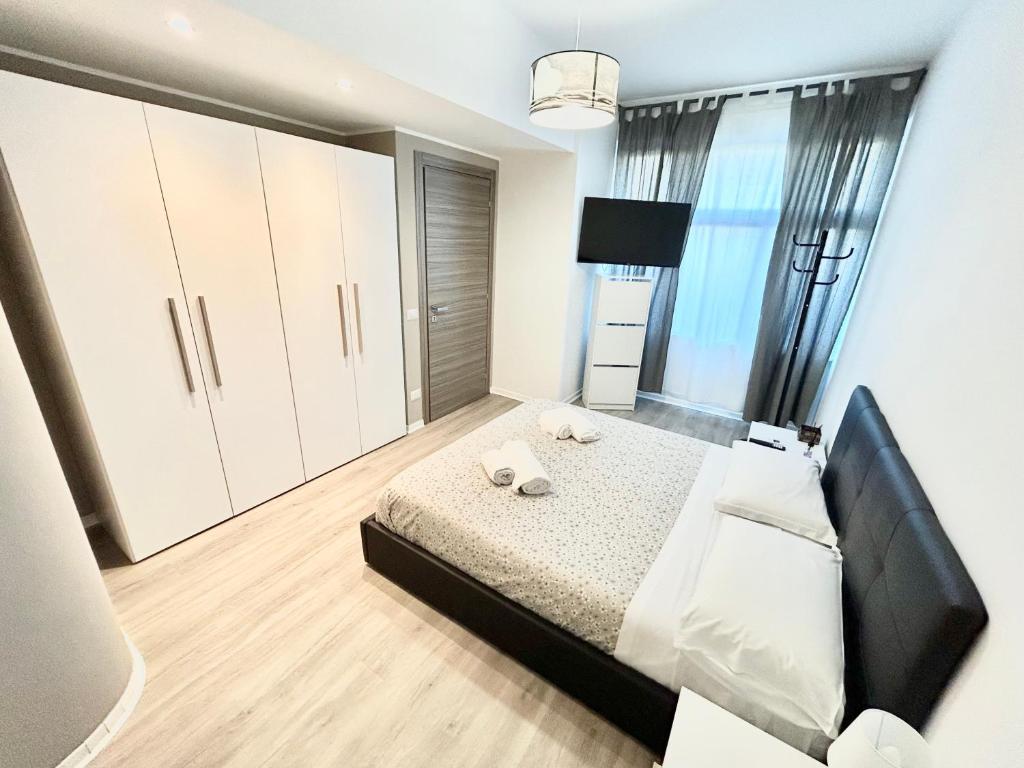 a bedroom with a bed and a large window at Un Letto Ideale EUR in Rome