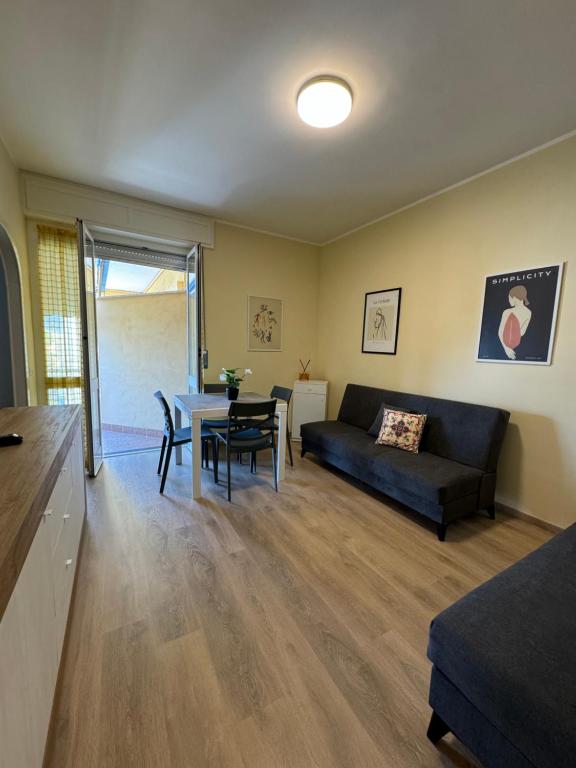 a living room with a couch and a table at Casa Facetti presso HOTEL KRISTALL in Diano Marina