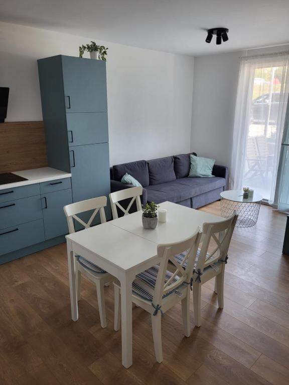 a kitchen and living room with a white table and chairs at Apartment Nikolaj in Labin