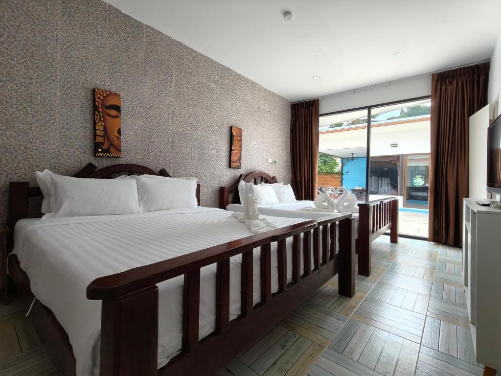 Postel nebo postele na pokoji v ubytování Baankasemsuk Resort 般咔 深宿
