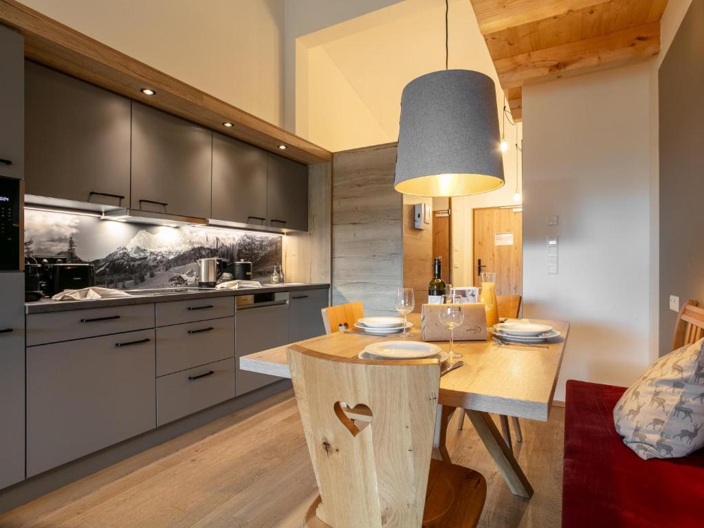 a kitchen with a wooden table and a dining room at Apart33 Top 2-15 in Haus im Ennstal