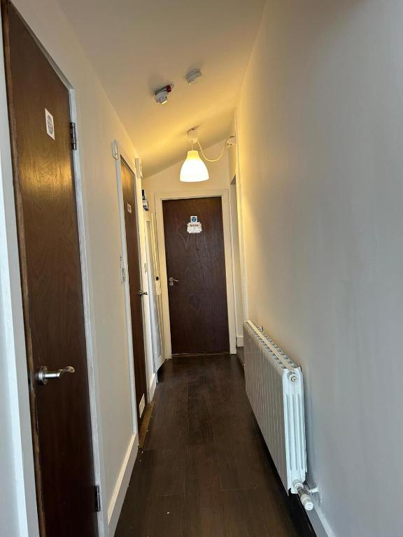 a hallway with a brown door and a hallwayngth at Sarsfields Communities in Dolphinʼs Barn