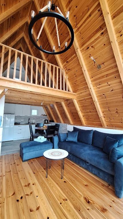 a living room with a blue couch and a table at Bella Home in Rap