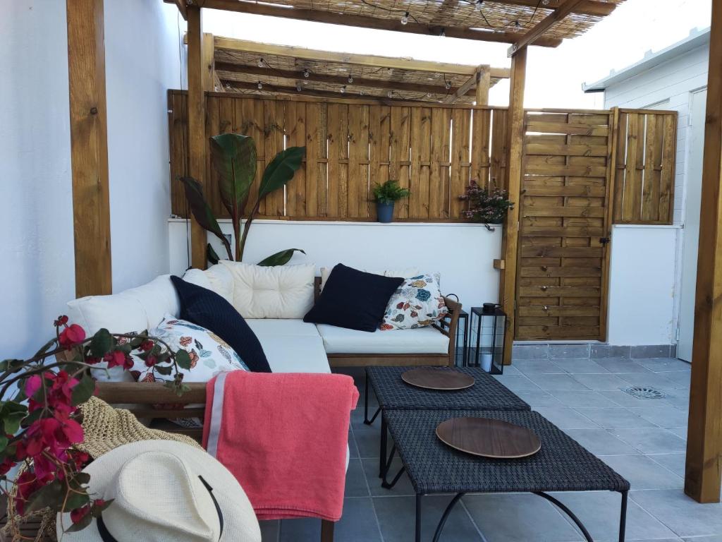a living room with a couch and two tables at Casa Laida in Sanlúcar de Barrameda