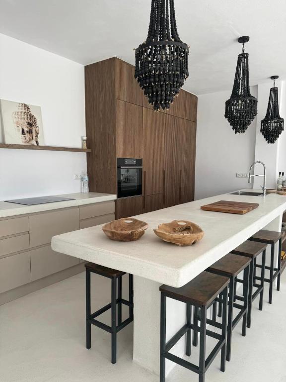 a kitchen with a table with wooden bowls on it at GR - Villa La Punta Mikri in Plaka