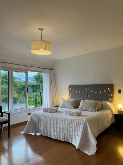 a bedroom with a large bed with a large window at Mein haus in Salta