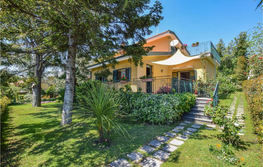 a yellow house with a staircase in the yard at Amazing Apartment In Trecastagni in Trecastagni