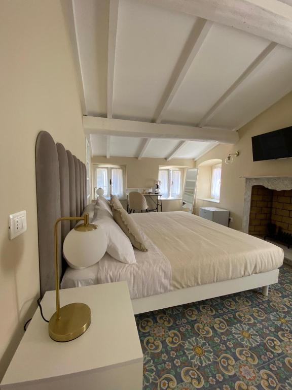 a bedroom with a large bed and a fireplace at Fiasella 21 in Sarzana