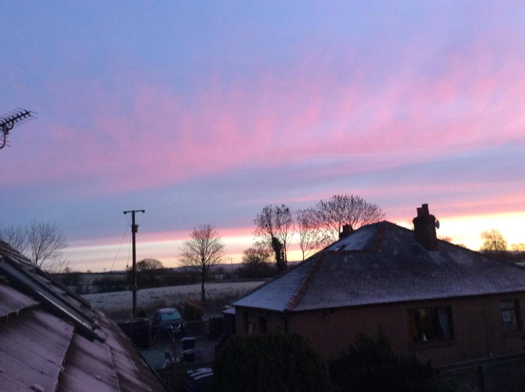 a view of a sunset from the roof of a house at wonderful 4 bedroom cottage sleeps 8 in Carlisle