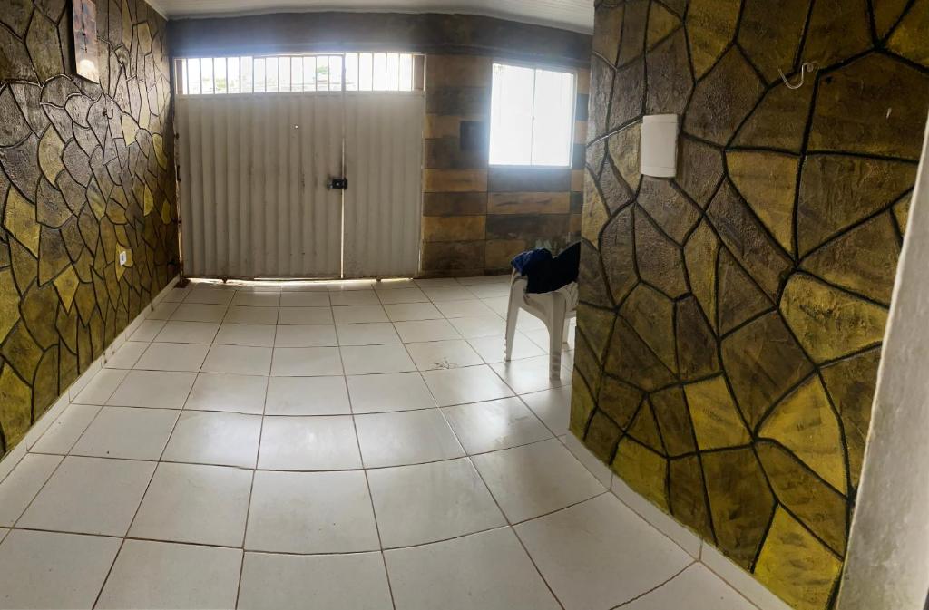 a hallway with a tile floor and a door at Casa in Garanhuns