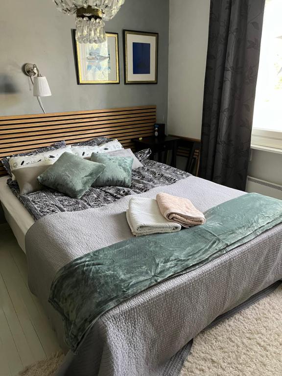 a bedroom with a bed with two pillows on it at Idyllic upstairs apartment with two bedrooms in Joensuu