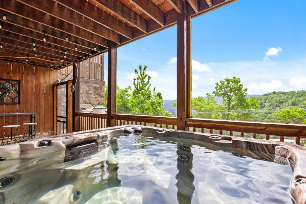 an indoor pool in a house with a large window at Classy Bear Cabin - Summit Views of Ober Mountain, Hot Tub, 3 King Beds, 2 Mi to Downtown in Gatlinburg