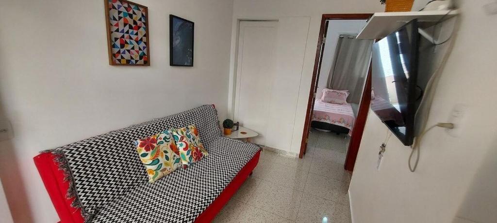 a living room with a couch with a pillow on it at SUH Copacabana 01 Nice Balcony Close To Beach in Rio de Janeiro