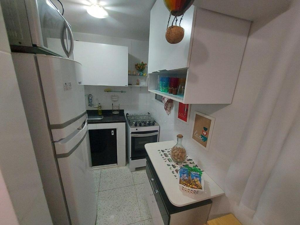 a kitchen with a white refrigerator and a counter top at SUH Copacabana 01 Nice Balcony Close To Beach in Rio de Janeiro