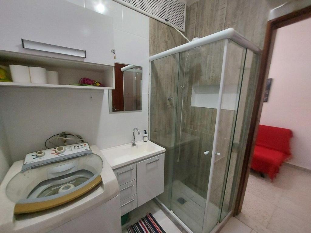 a bathroom with a washing machine and a shower at SUH Copacabana 01 Nice Balcony Close To Beach in Rio de Janeiro